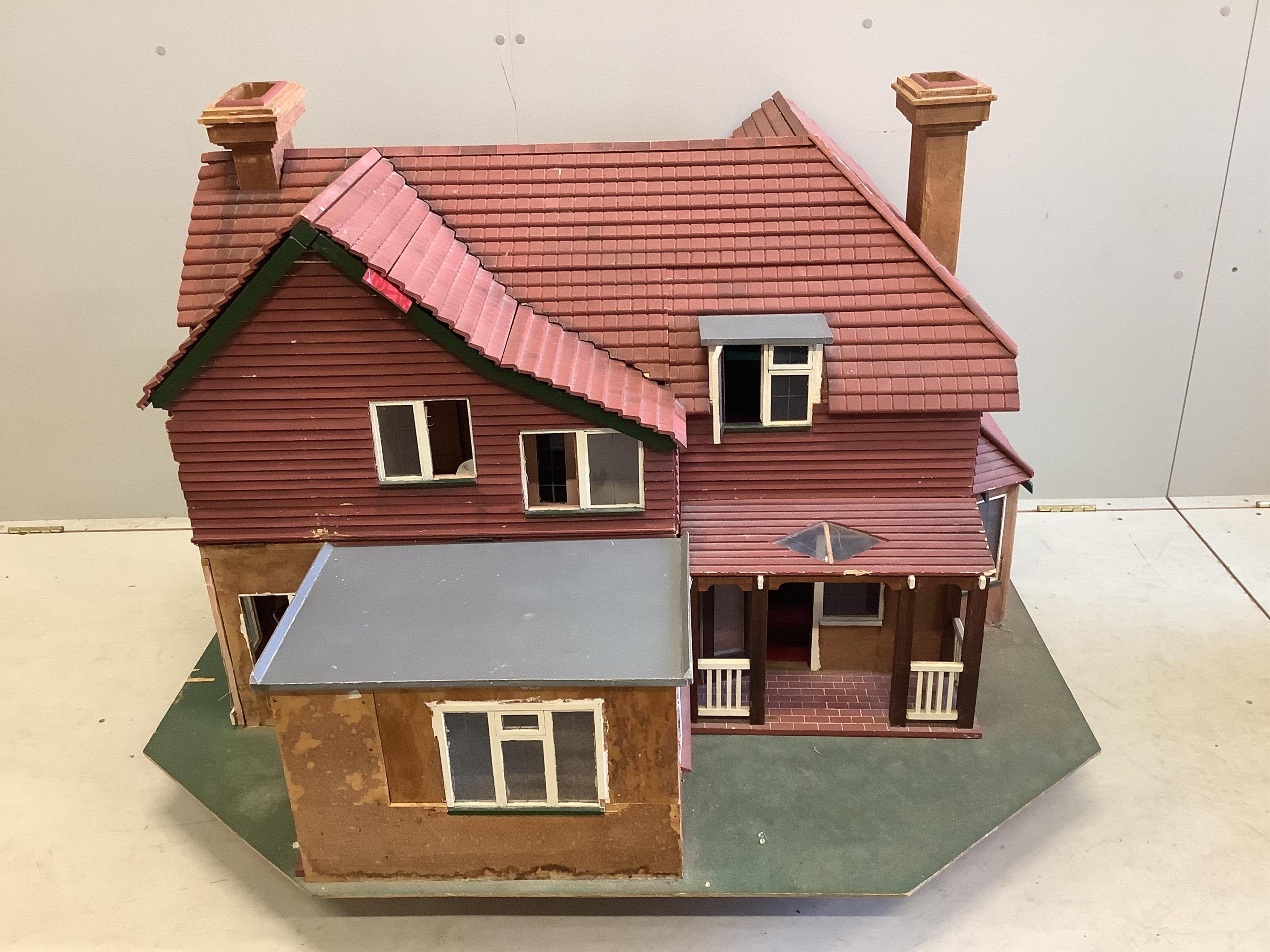 A mid 20th century scratch built mock Tudor doll’s house with some accessories, width 120cm, height 76cm. Condition fair.